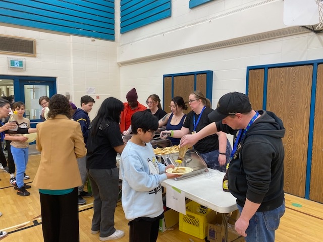 Volunteers at Father Leo Green School serving pancake breakfast
